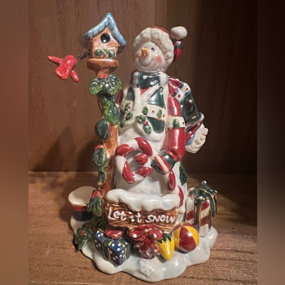 Let it snow snowman with birdhouse and attached bird.